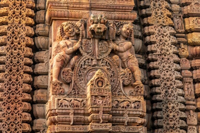 Detailed stone carvings on the walls of Lingaraj Temple in Bhubaneswar, India.